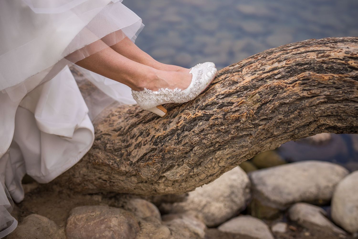 Detail shots of wedding dress fabric flowing over rocky mountain terrain.