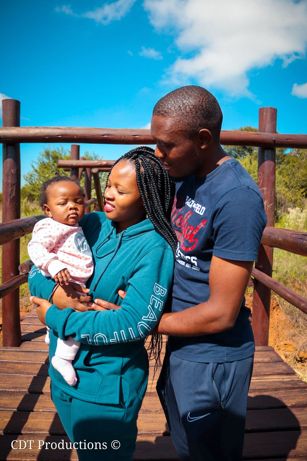 Family photography, family taking a picture together at the bridge showing a new journey that is yet to come with their new born.
