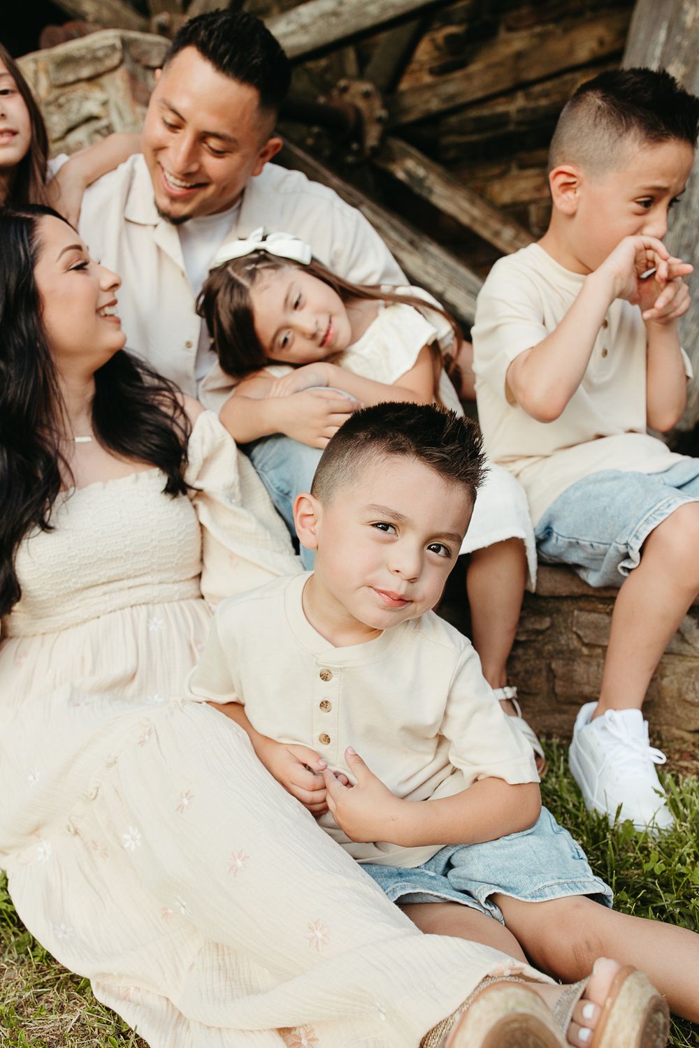 Candid family moment captured by rustic wooden structure.