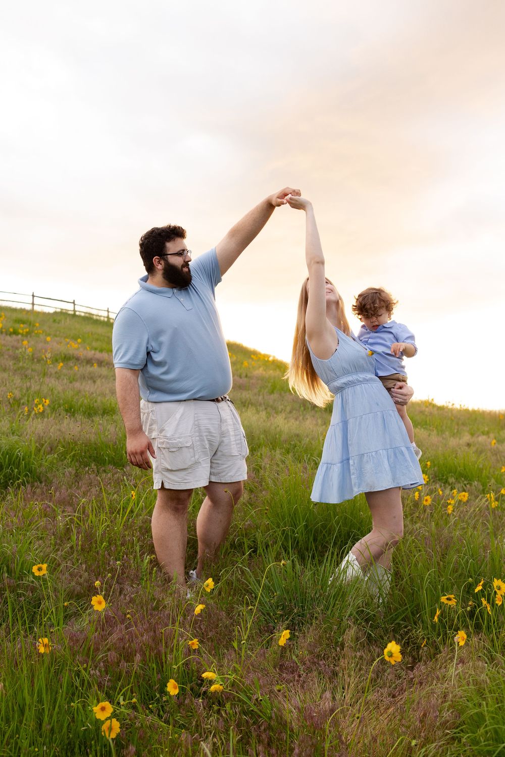 Candid family moments captured while playing in a field of wildflowers at sunset.