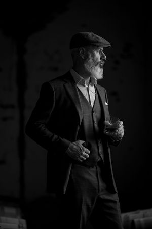 Glenn Nash wearing a handmade Houndstooth Tailors Suit Peaky Blinders style in the Corowa Distillery Barrel Room.