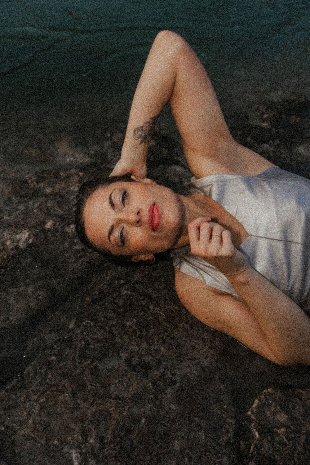 Artistic portraits on dark background capturing intimate emotional expressions in low light.