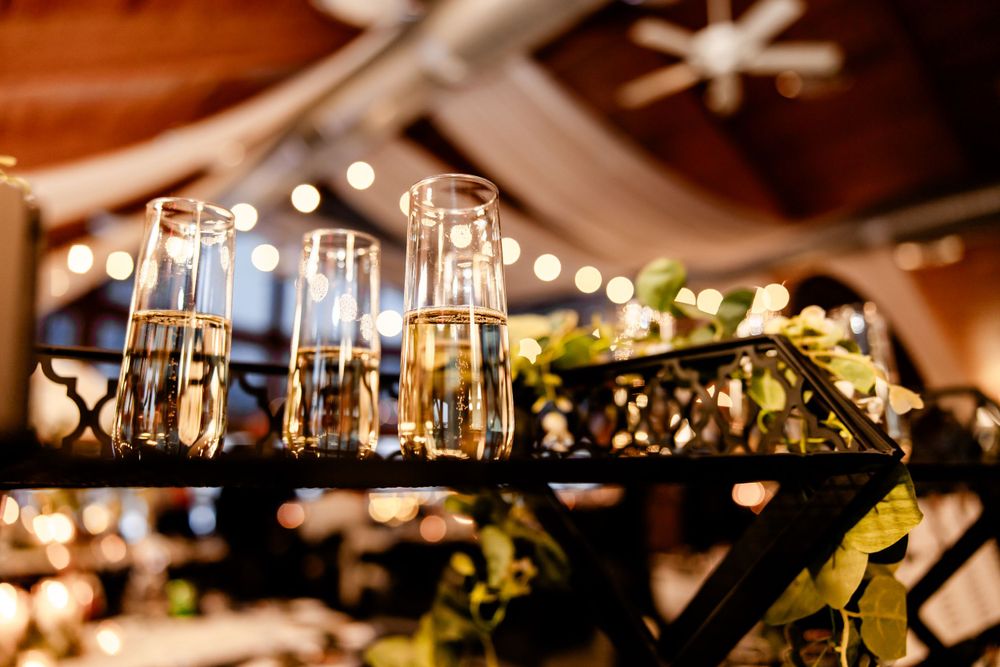 Elegant wedding reception decor with twinkling lights and hanging decorations.