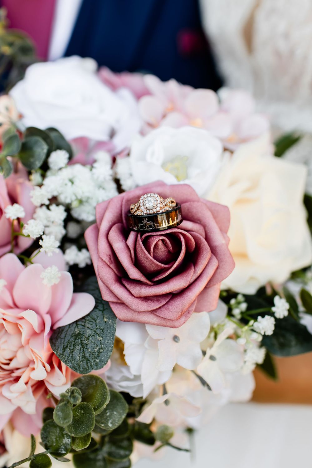 Delicate pink and white wedding flower arrangement with roses and eucalyptus.