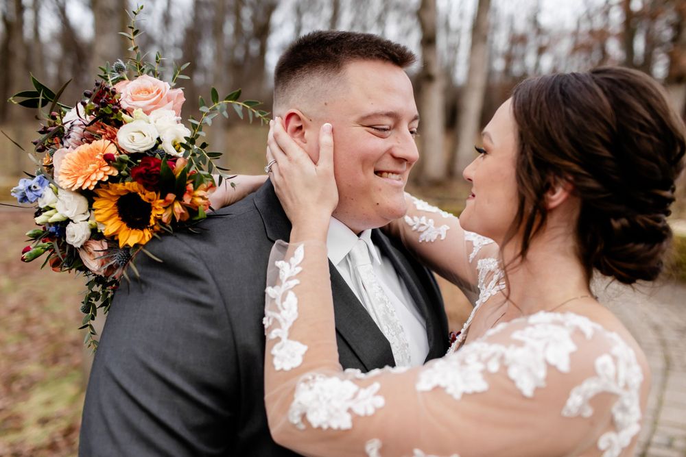 Intimate wedding couple portraits with autumn-colored floral bouquet details.