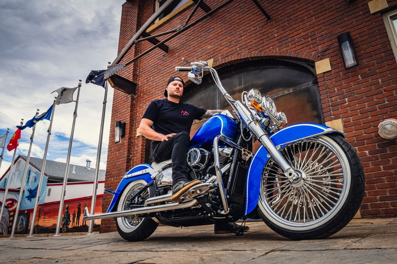 Men's small business branding photo.  Motorcycle build, urban setting.