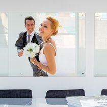 A joyful moment captured in bright interior setting with floral bouquet and formal attire.