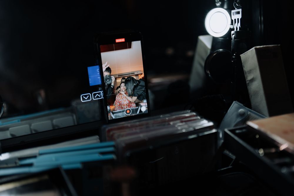 Dark photography setup with camera equipment and monitor display in low light conditions.