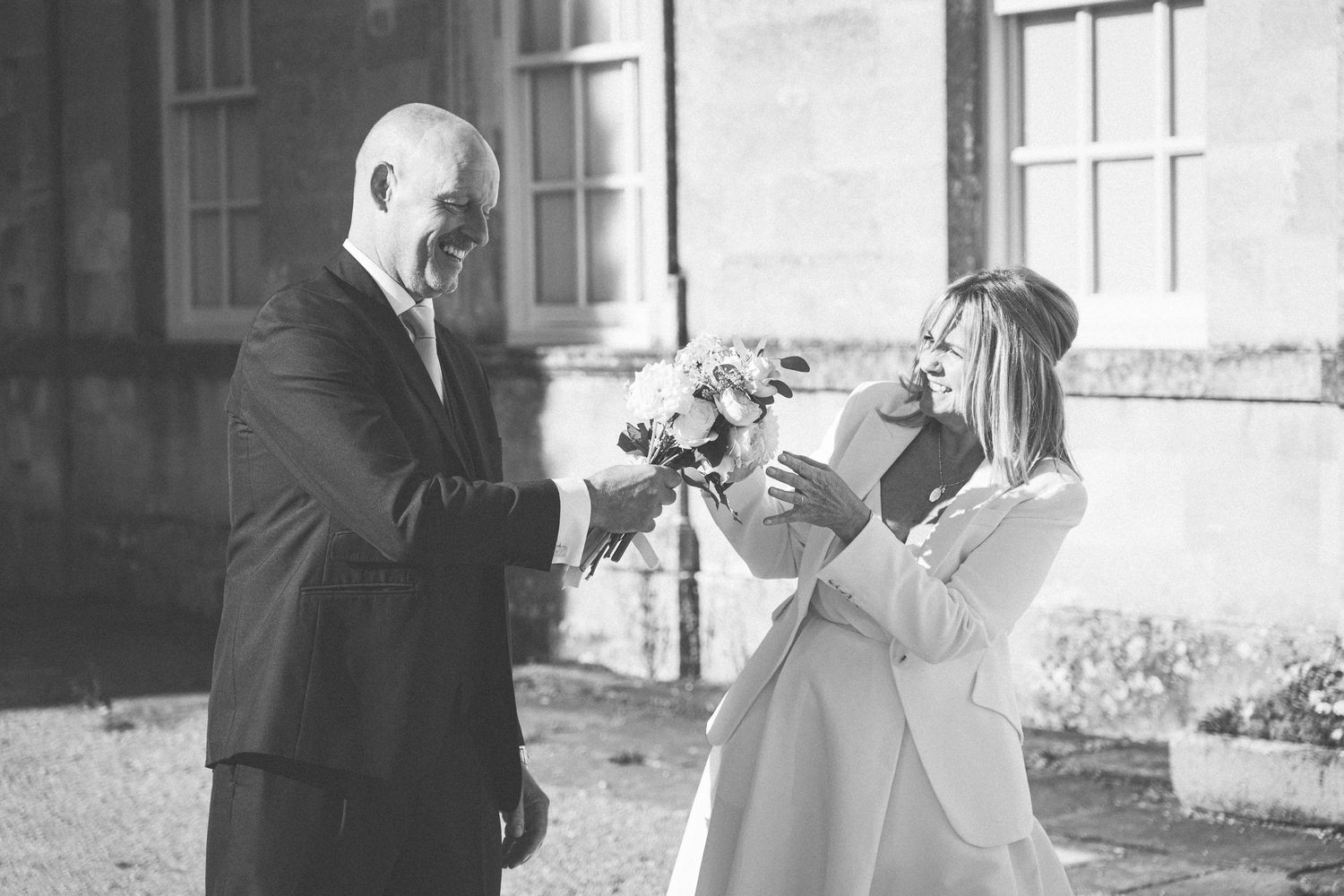 Black and white wedding photography capturing natural smiles and movements.