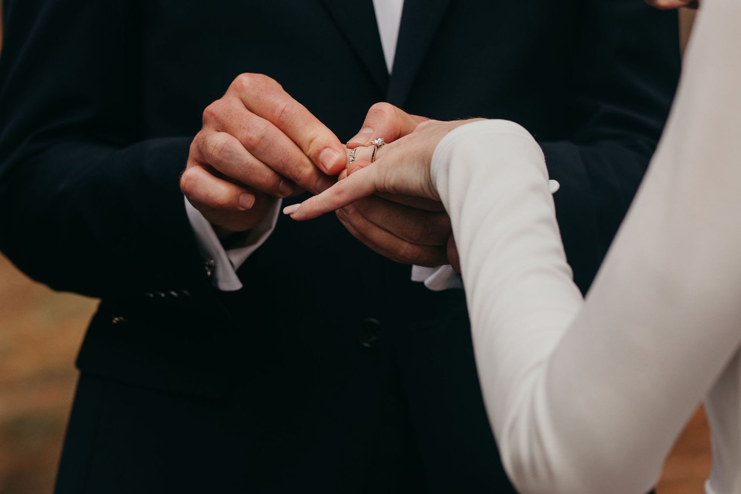 groom placing ring on brides finger