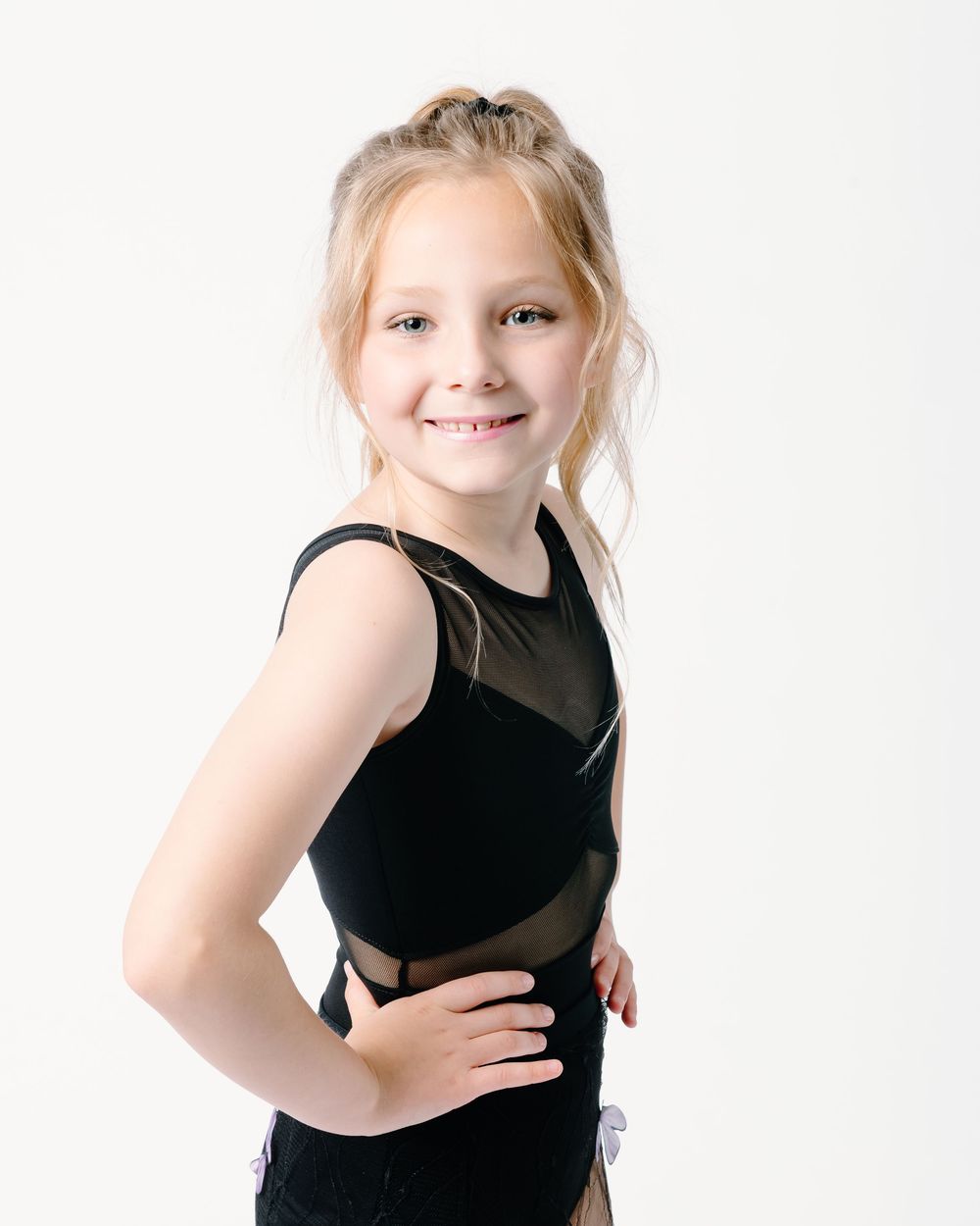 Three studio portraits of a young dancer in a black leotard showing graceful poses against a white background.