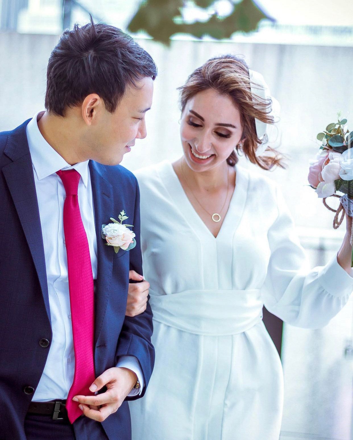 Elegant wedding couple sharing intimate moment in formal attire.