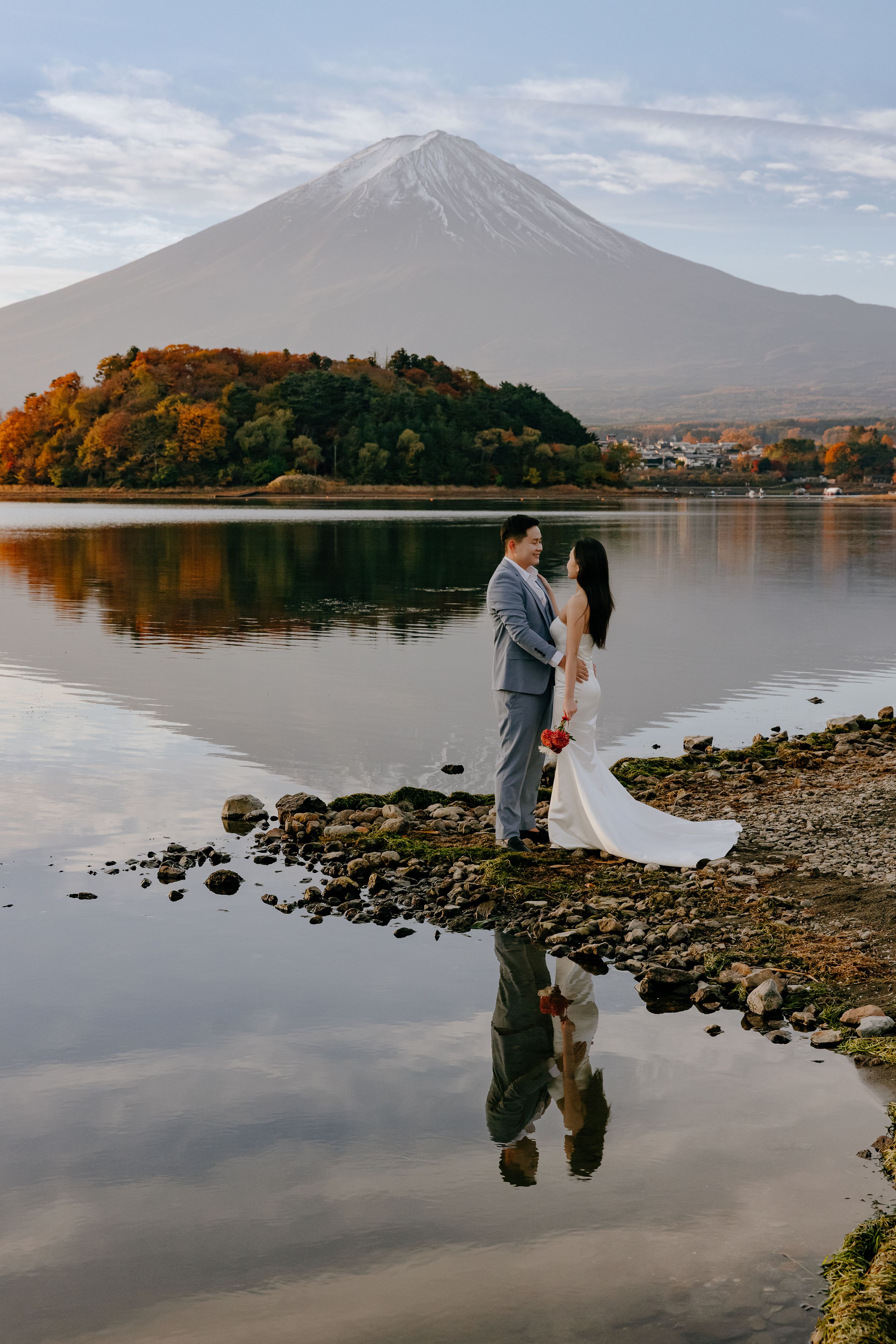 Scenic wedding photos captured at Lake Kawaguchiko with Mount Fuji creating a majestic backdrop during autumn season.
