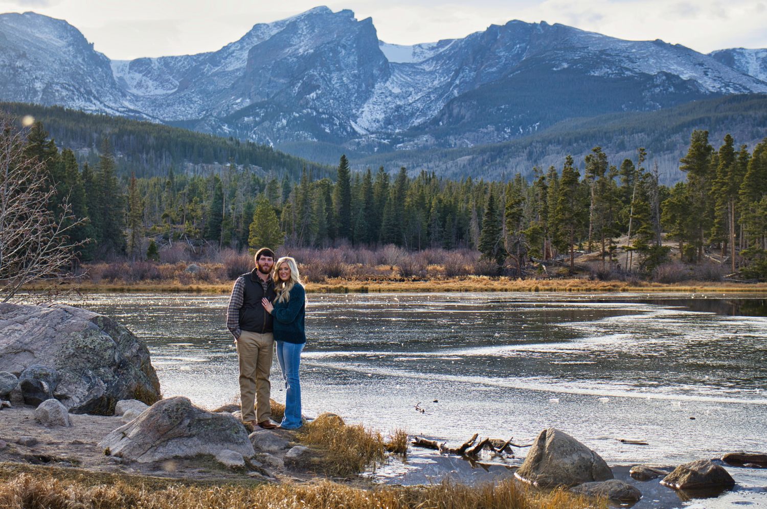 Couple in front of Sprague Lake after their proposal in the RMNP. Pixcapades | The Rocky Mountain Proposal Photographer