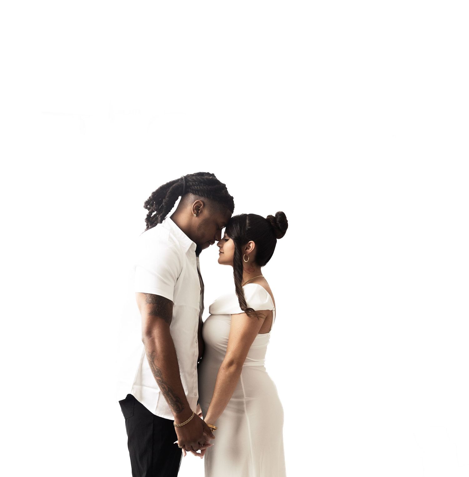 Minimalist portrait of couple with camera against white background.