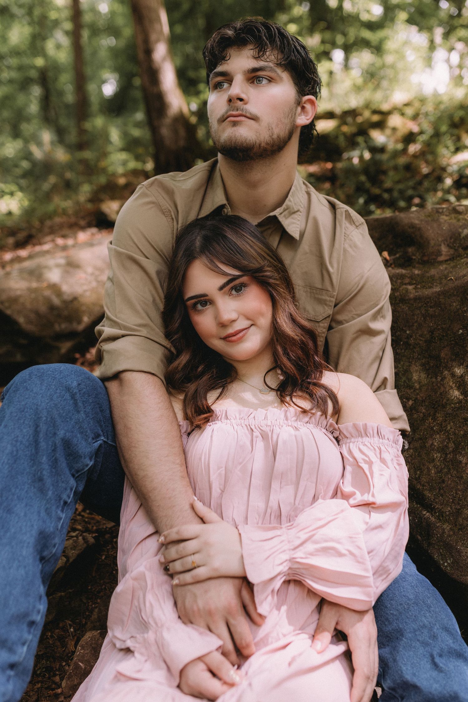 Couple in contrasting outfits shares intimate moment in wildflower field.