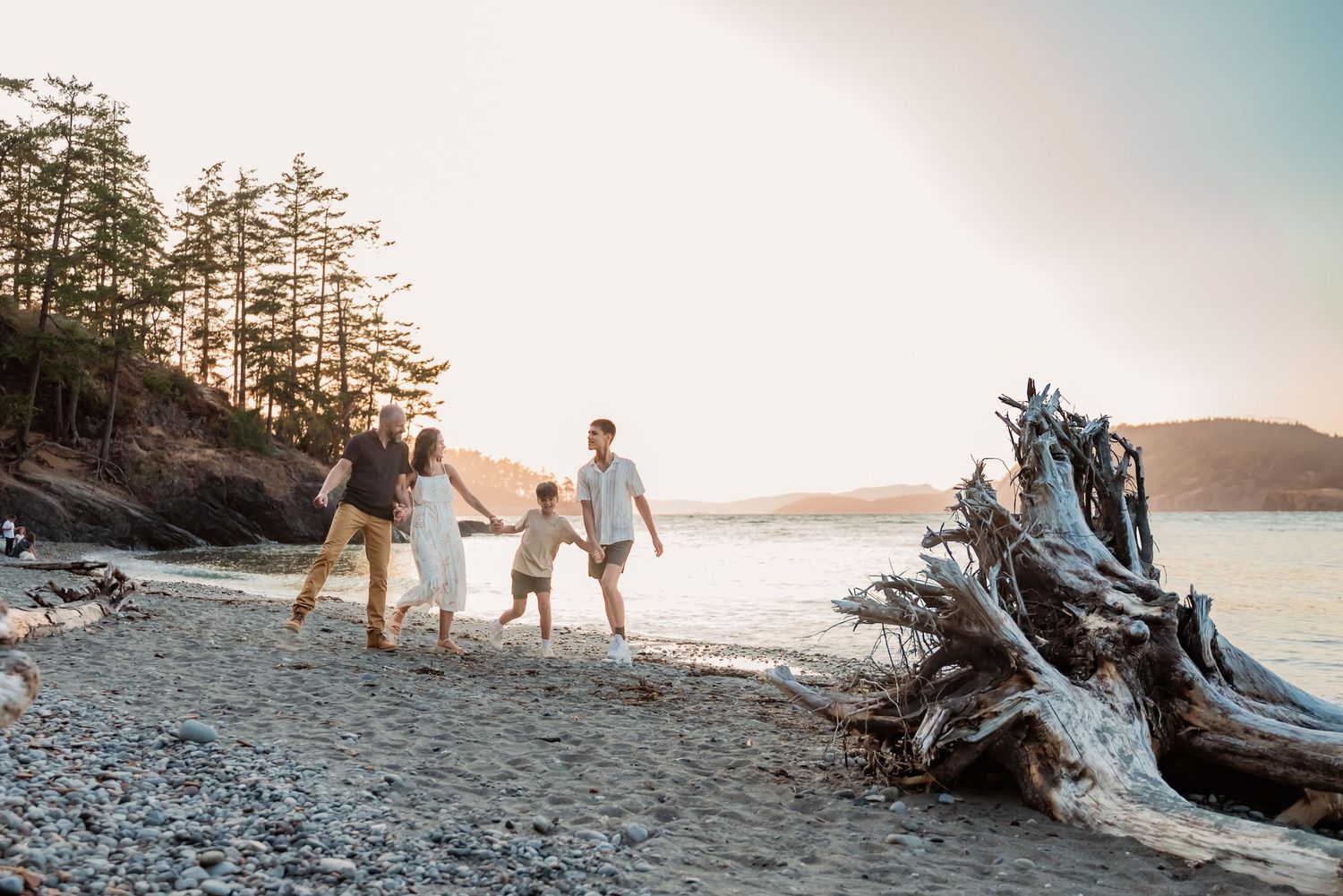 Family plays on the beach at Deception Pass State Park, Whidbey Island
