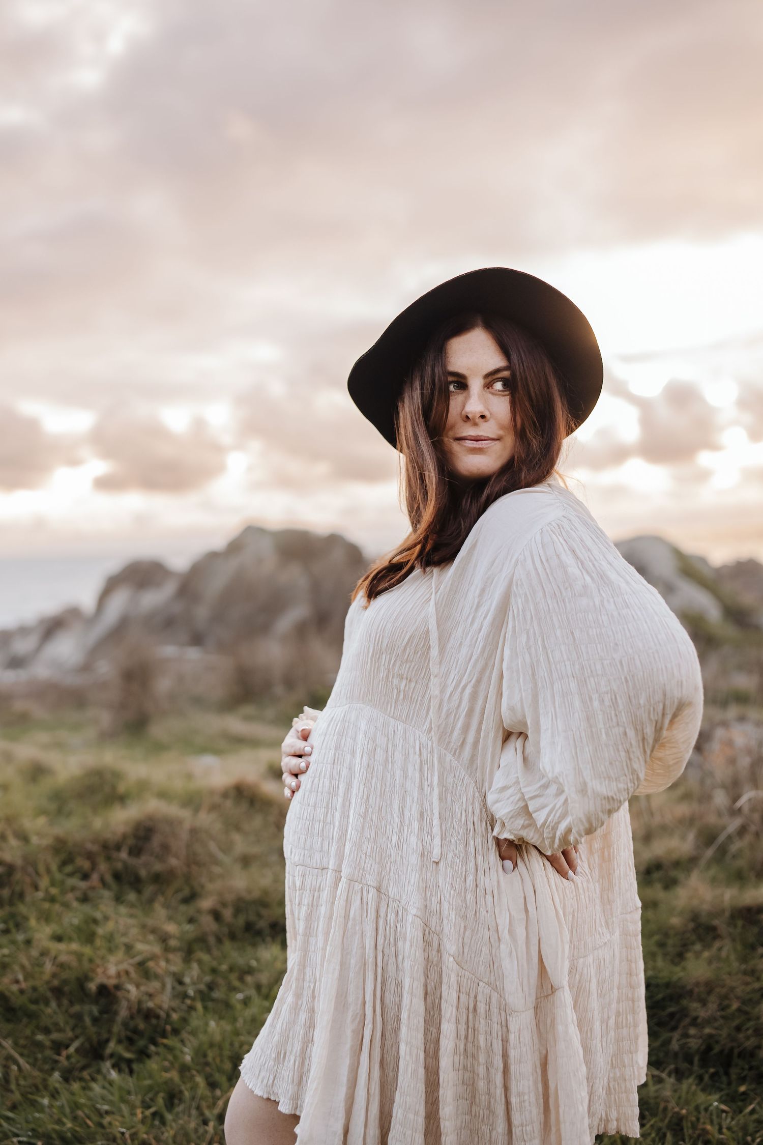 Maternity portrait of expectant mother during golden-hour at beach Westport NZ