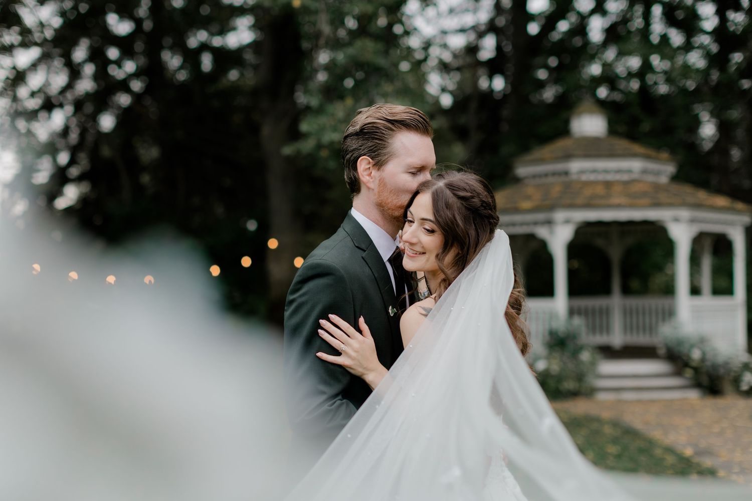 Intimate moment between newlyweds in a sunny outdoor setting.