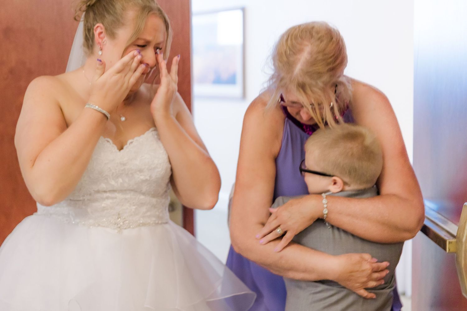 An emotional moment captured during wedding preparations.