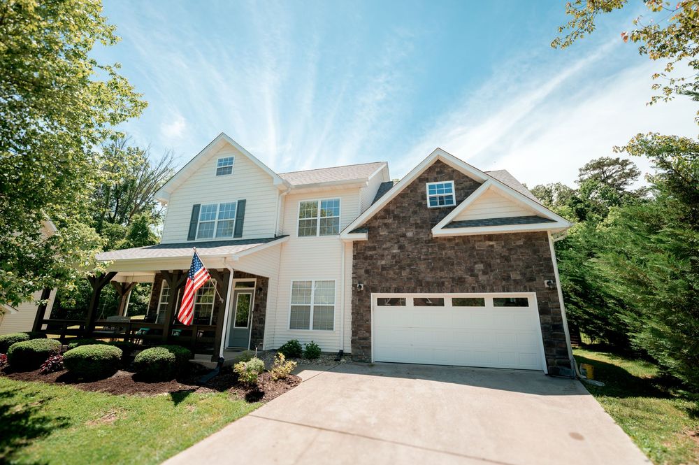 Modern suburban homes with pristine driveways and well-maintained lawns in a peaceful residential neighborhood.