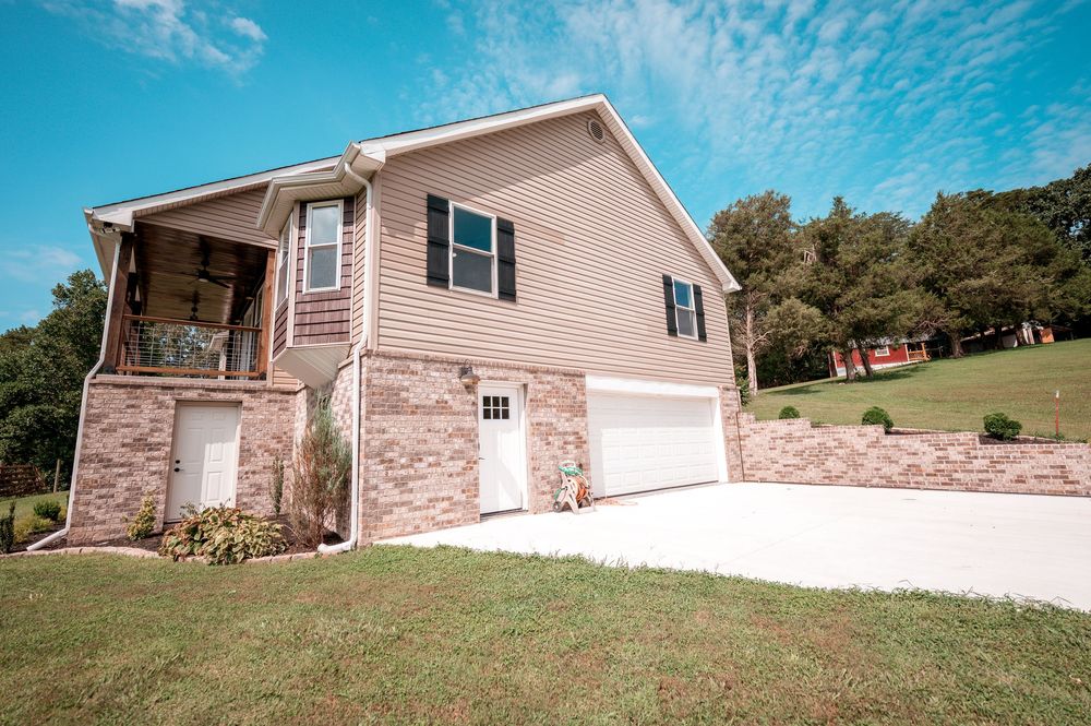 A panoramic collage showing multiple angles of a brick and vinyl sided ranch-style house with attached garage and landscaping.