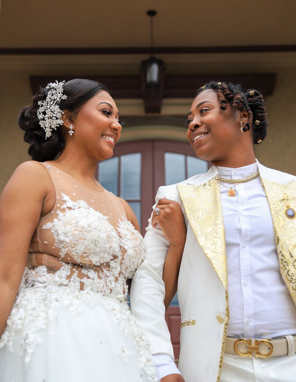 Wedding couple sharing intimate moment in elegant white and gold attire.