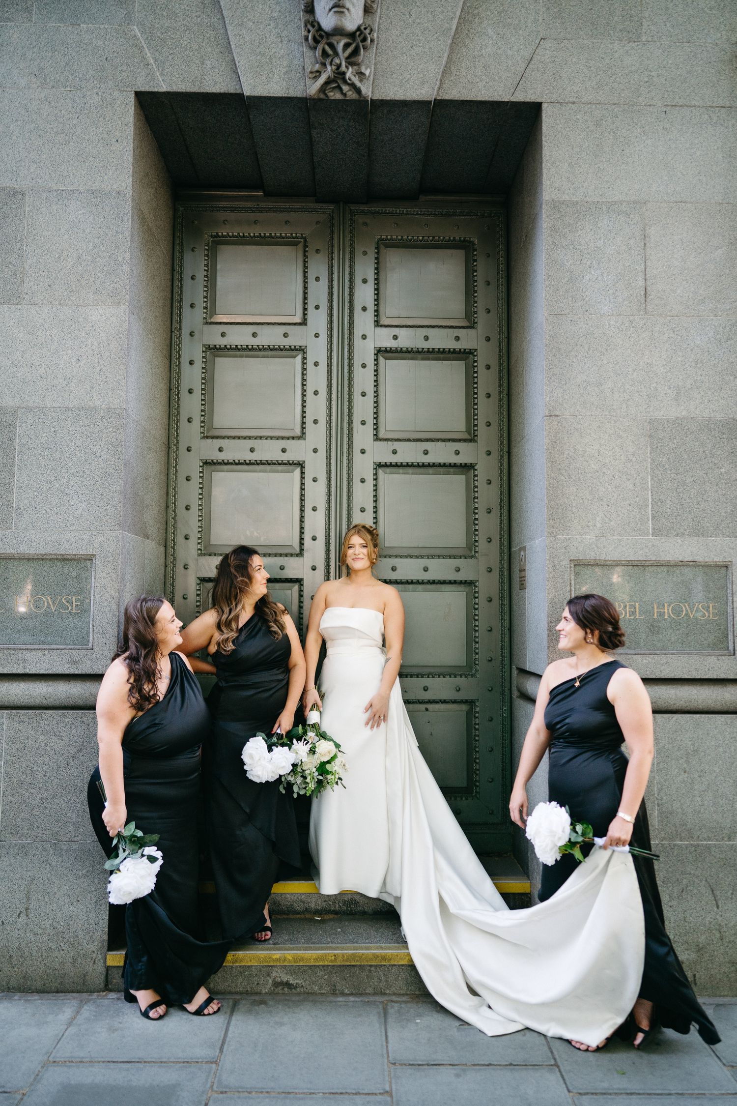 Bridal party pose outside historic London building, taken by editorial wedding photographer based in Hampshire