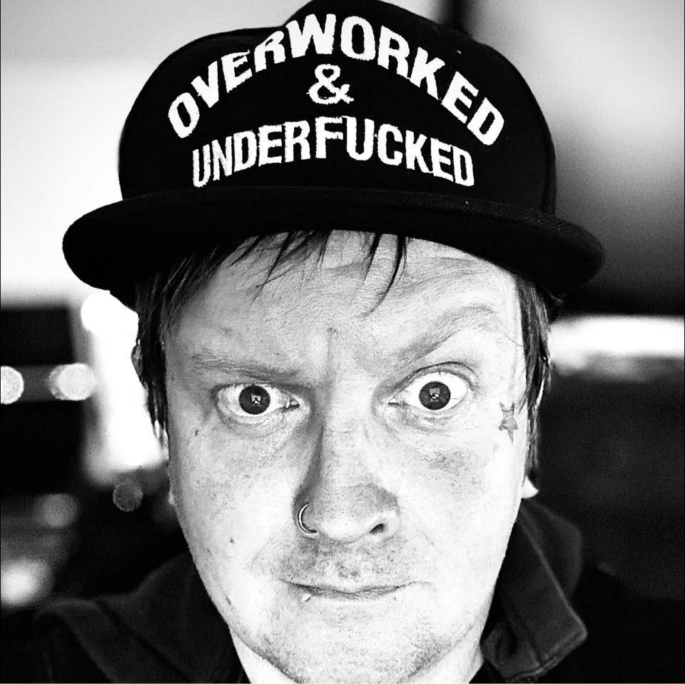 Black and white portrait showing person wearing hat with bold text statement.