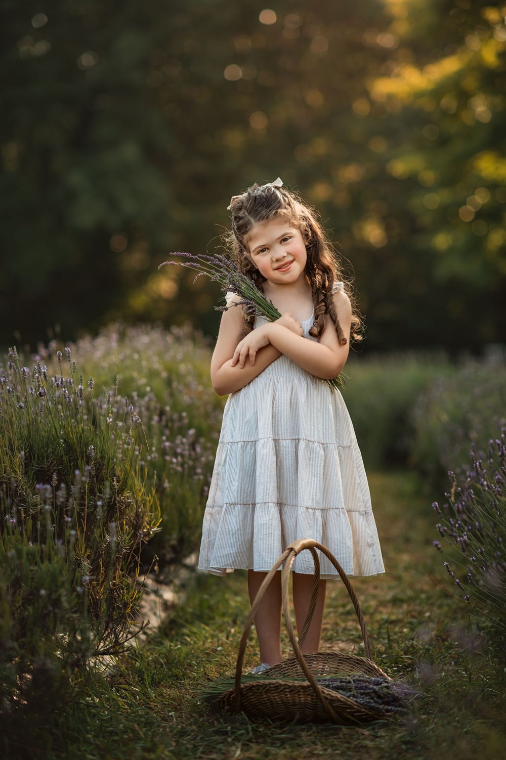 little girl holds bundle of lavender and smiles at north Georgia lavender farm