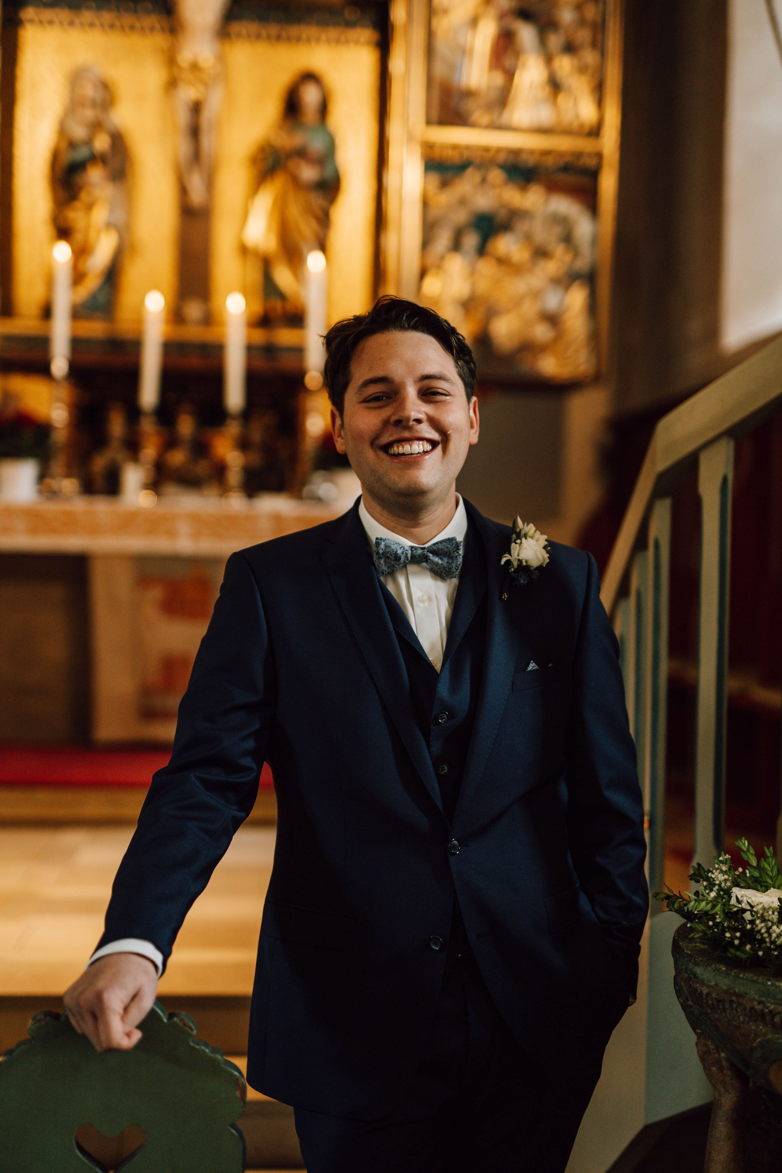 A joyful moment captured in front of religious iconography and candles.