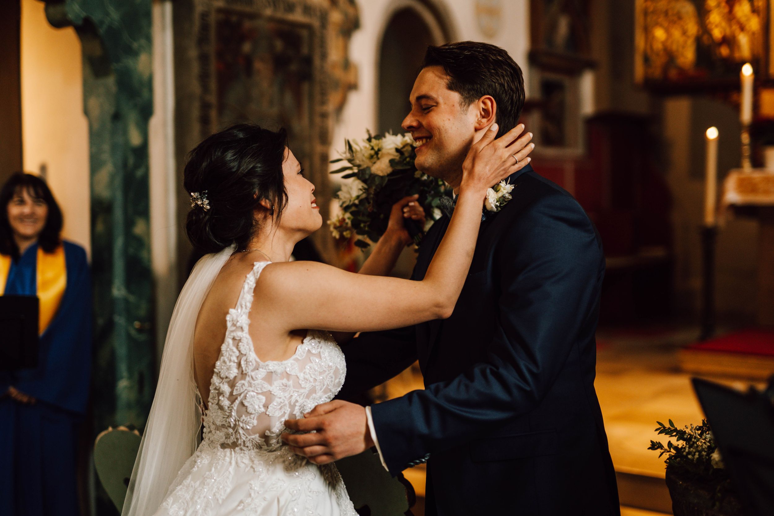 An intimate moment between newlyweds in a historic church setting.