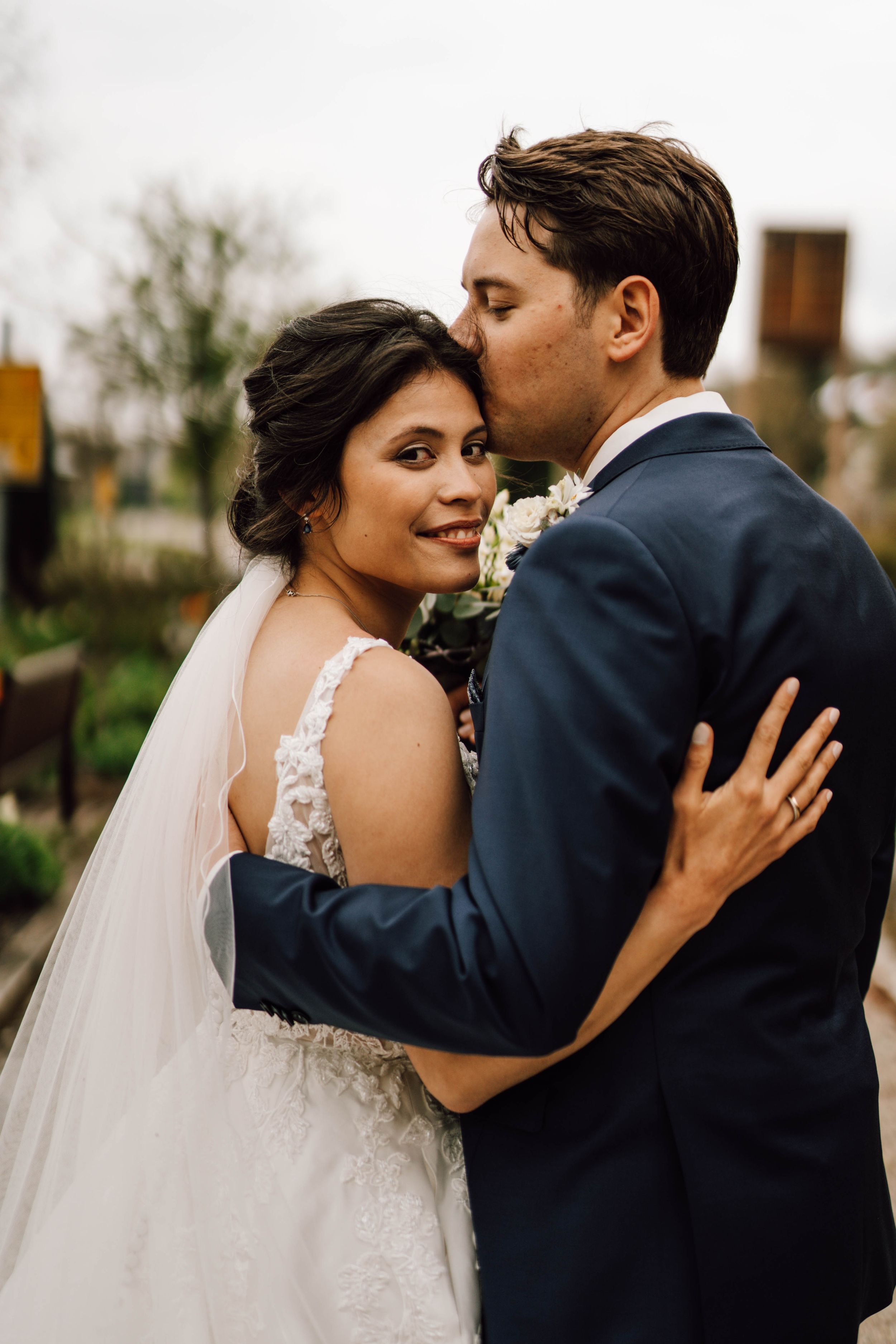 Tender wedding moment captured in a series of intimate outdoor portraits.