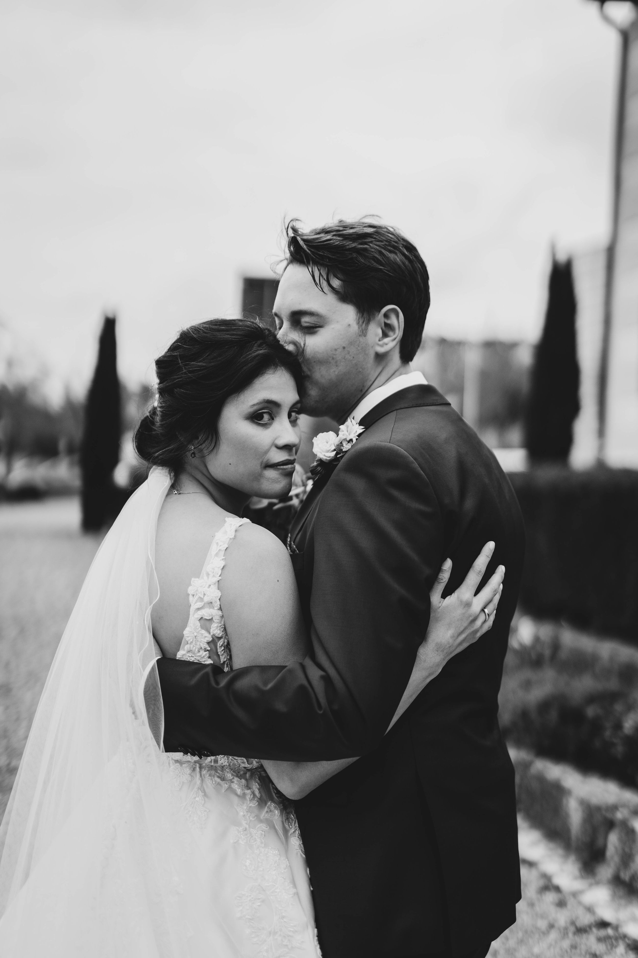 Black and white wedding portraits showing intimate moments between newlyweds.