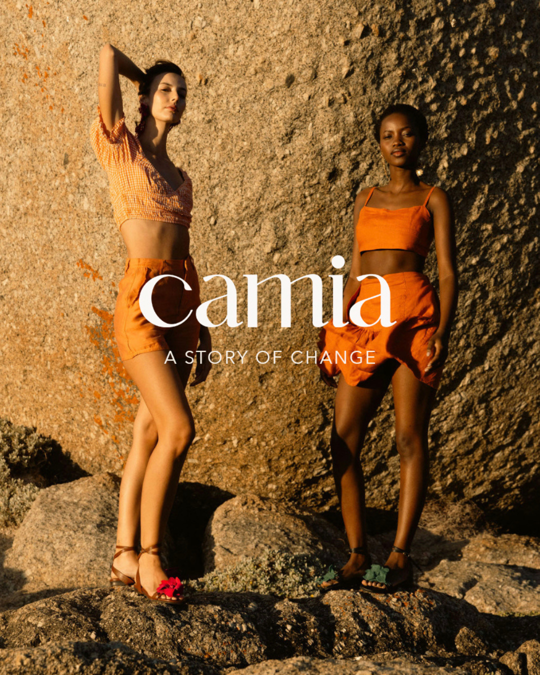 Fashion advertisement showing two models in orange outfits against textured wall with Camia text.