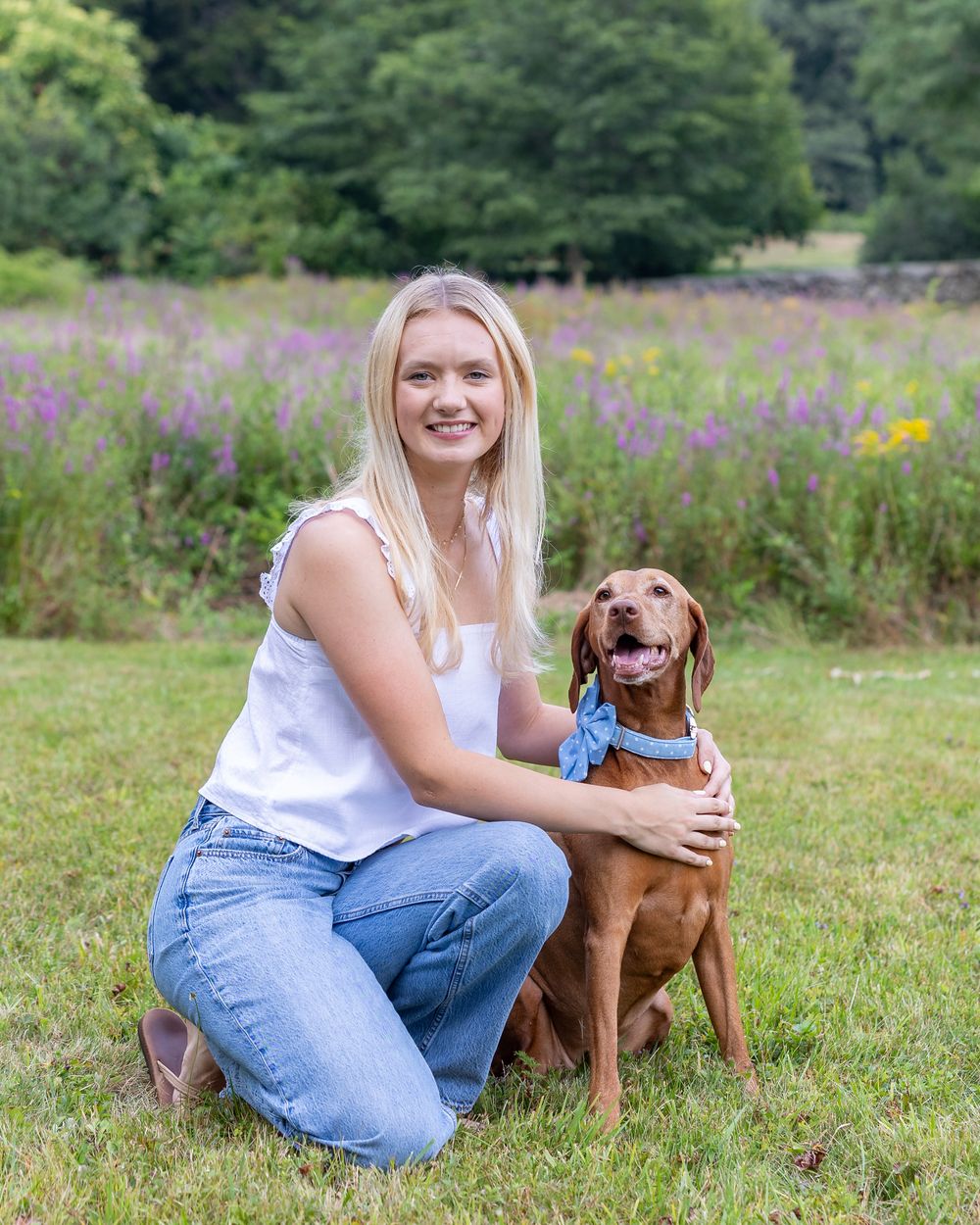 A high school senior poses for photos on the grounds Codman Estate in Lincoln, MA in a yearbook portrait session with Lisa West Photography.