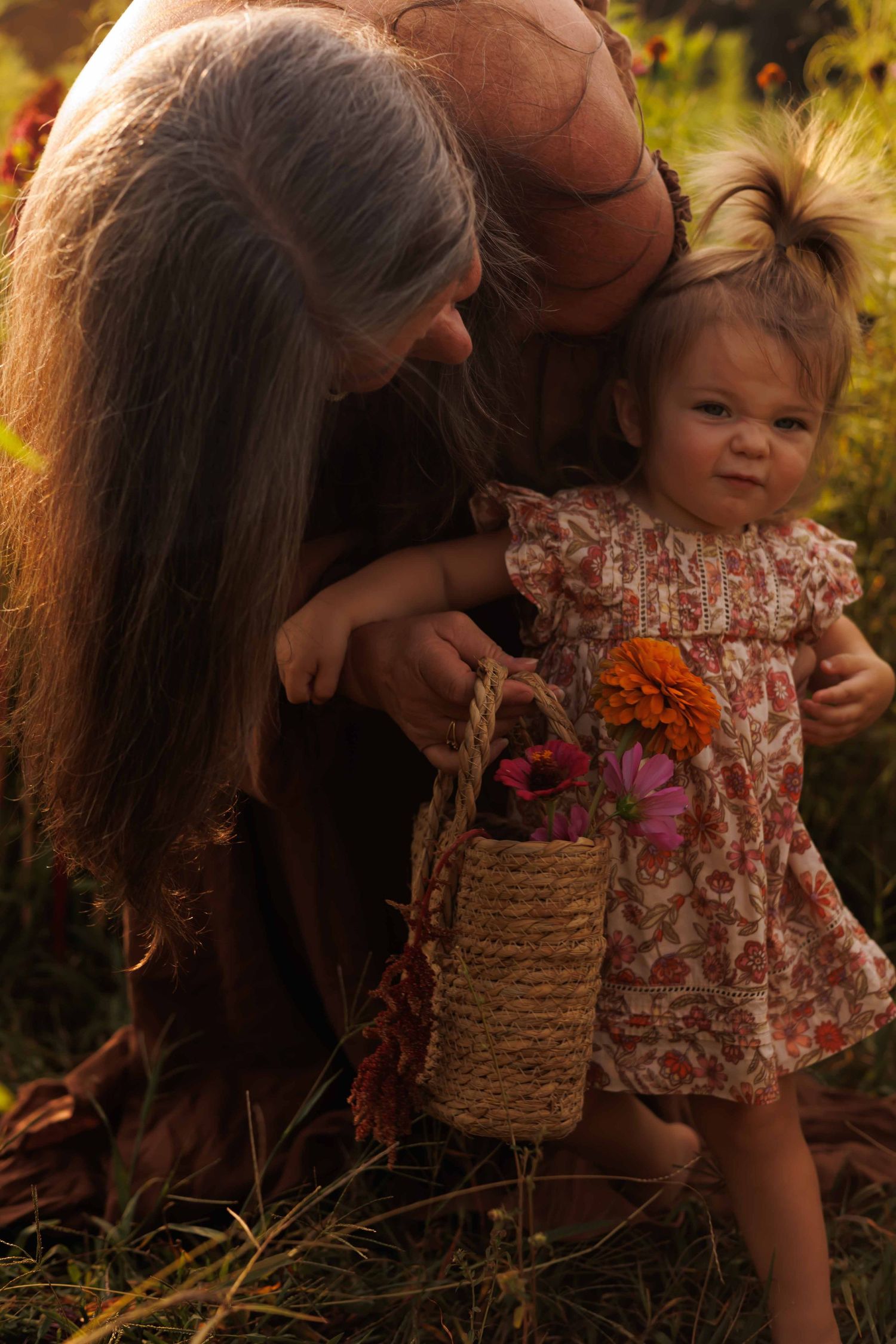 Parent and child with woven basket explore together in garden setting.