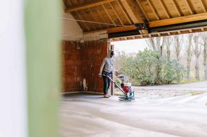 Interior view of a rustic wooden ceiling with exposed beams under natural lighting.
