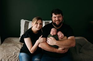 A cozy dark photography session showing loving affection and connection in a natural candid style.