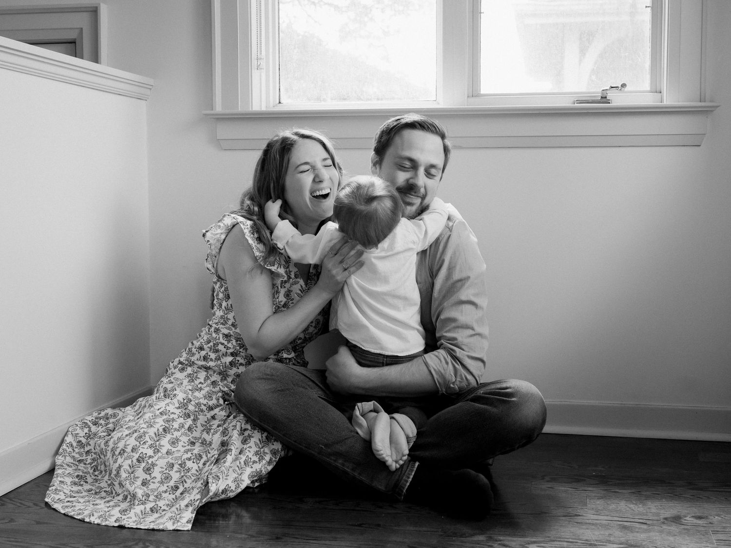 Family sharing intimate moments together on a bright indoor floor.