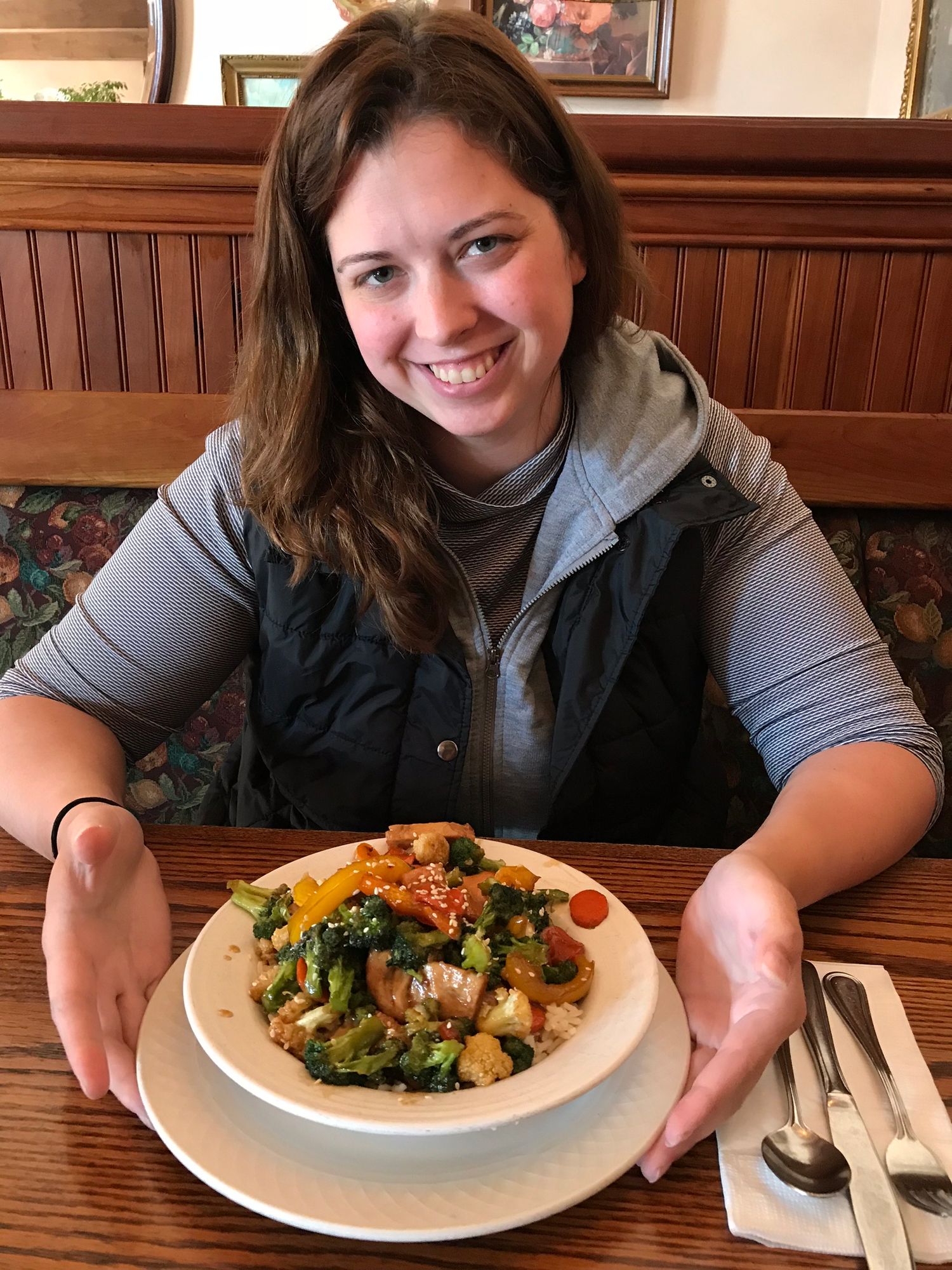 Restaurant dining scene with a colorful plate of vegetables and protein.