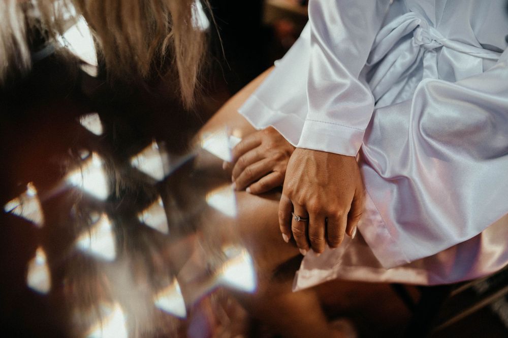 Close-up of hands with light reflections during wedding ceremony.