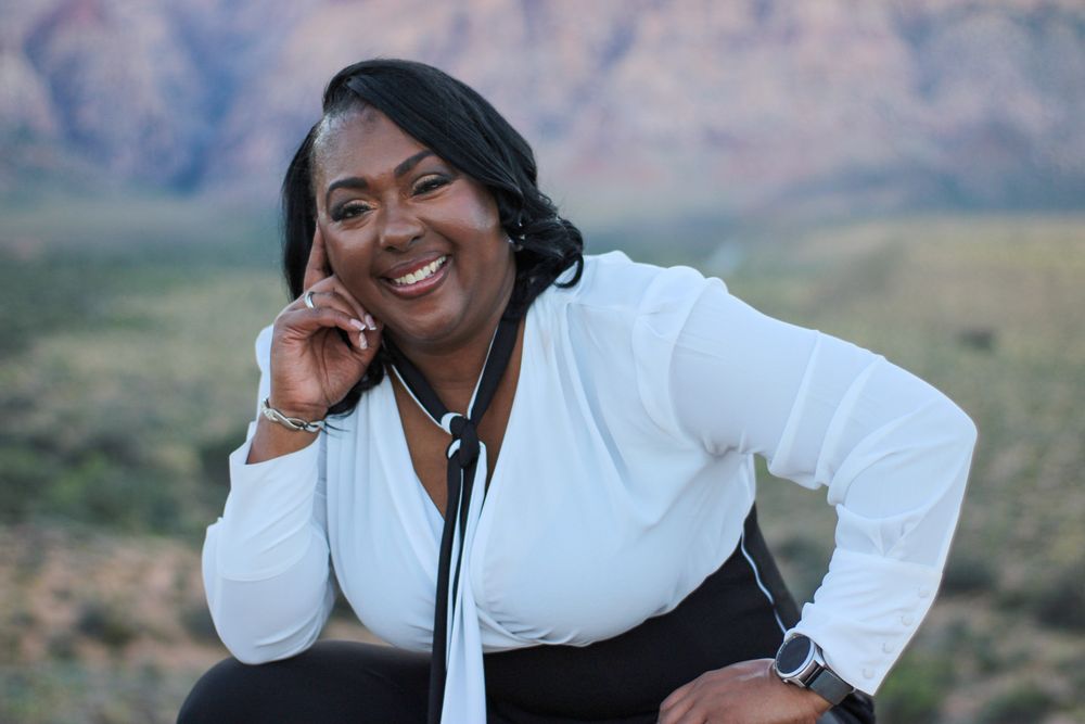 Smiling woman in white blouse with stethoscope posing at Red Rock Canyon Nevada.