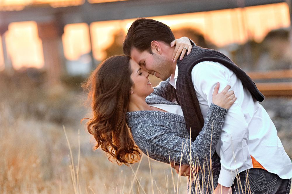 Couple shares tender moments during golden hour photoshoot in nature.