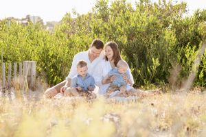 family sitting together on the sand in Portarlington