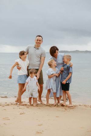 Family cuddling on the beach in Point Lonsdale, Victoria