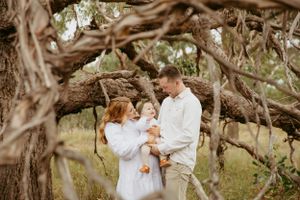 family cuddling in the bush in Teesdale, Victoria