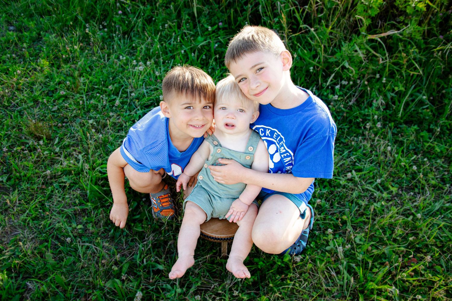 Children playing together on lush green grass during summer.
