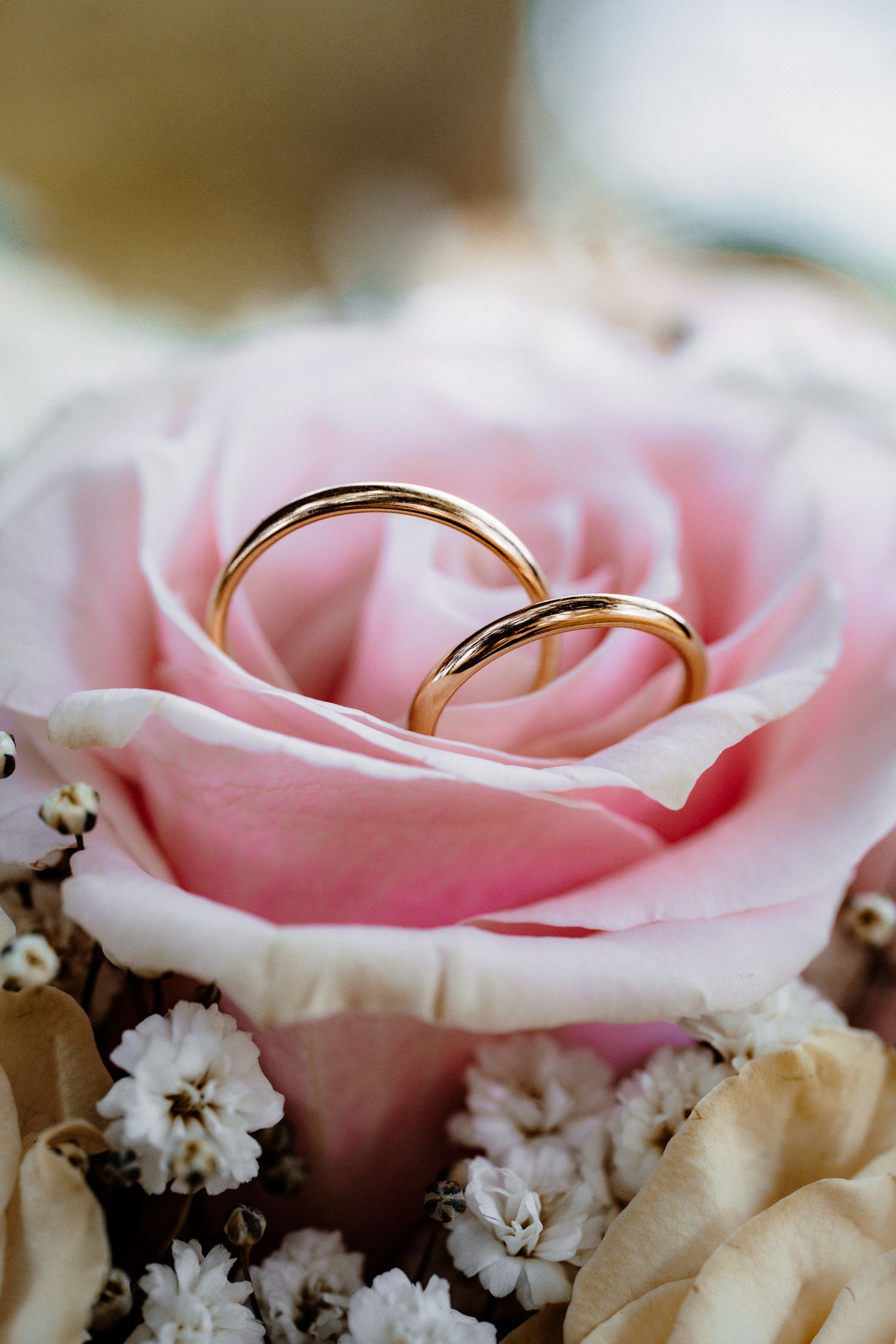 Beautiful bouquet of pink, white and deep red roses with a diamond ring nestled inside.