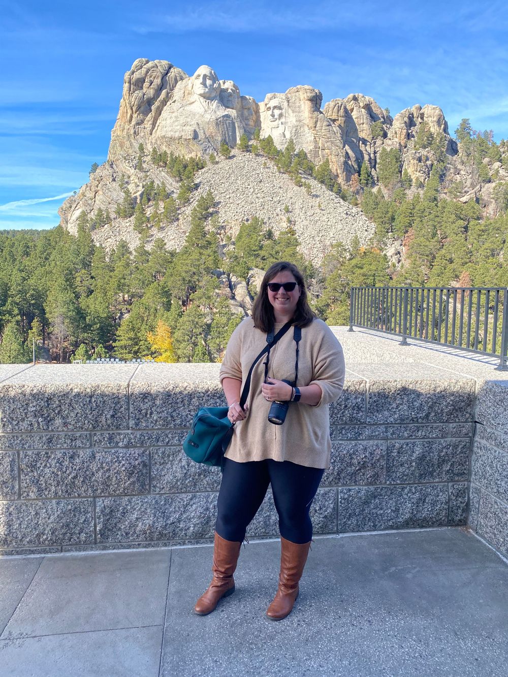 Visitor at Mount Rushmore viewing platform with the iconic monument in background.